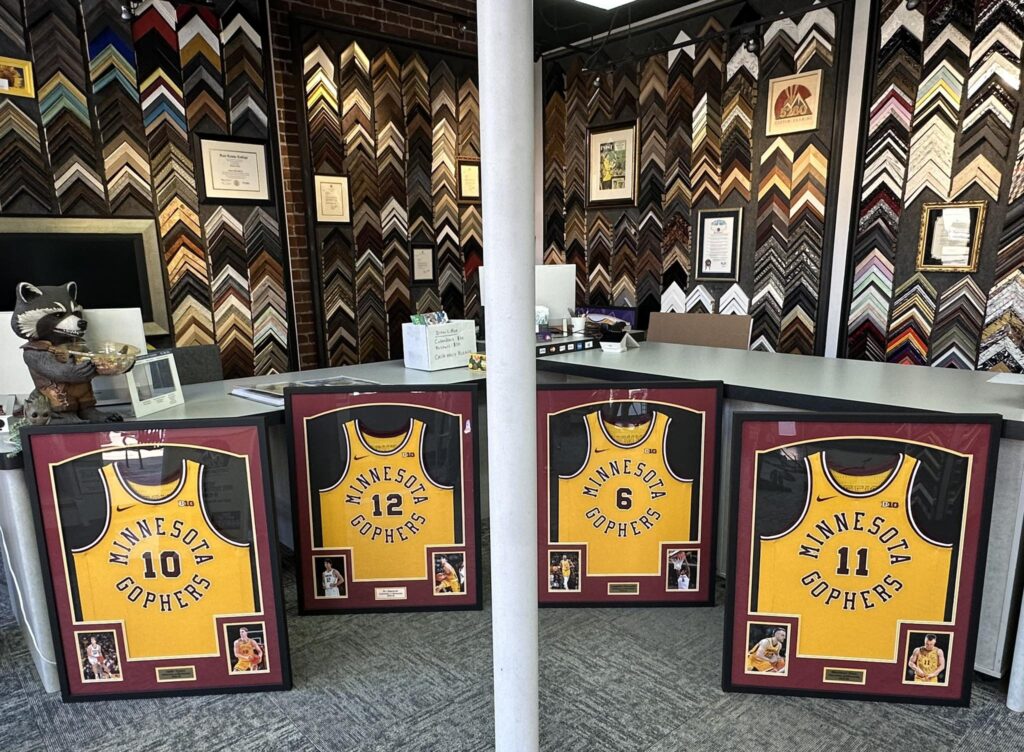 Custom framed Minnesota Golden Gophers basketball jerseys and sports memorabilia collection